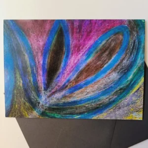 Abstract colorful artwork with dark envelope underneath.